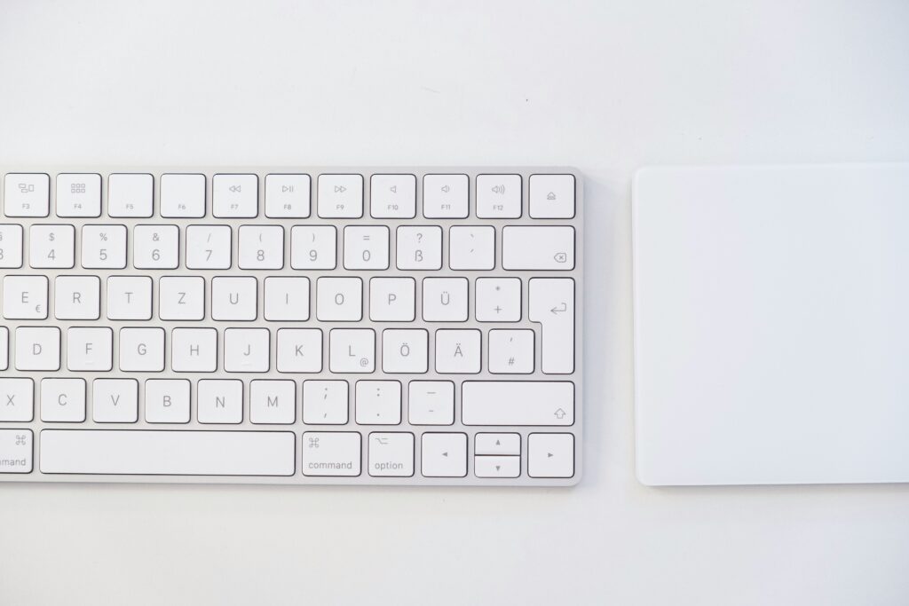 white apple keyboard on white table